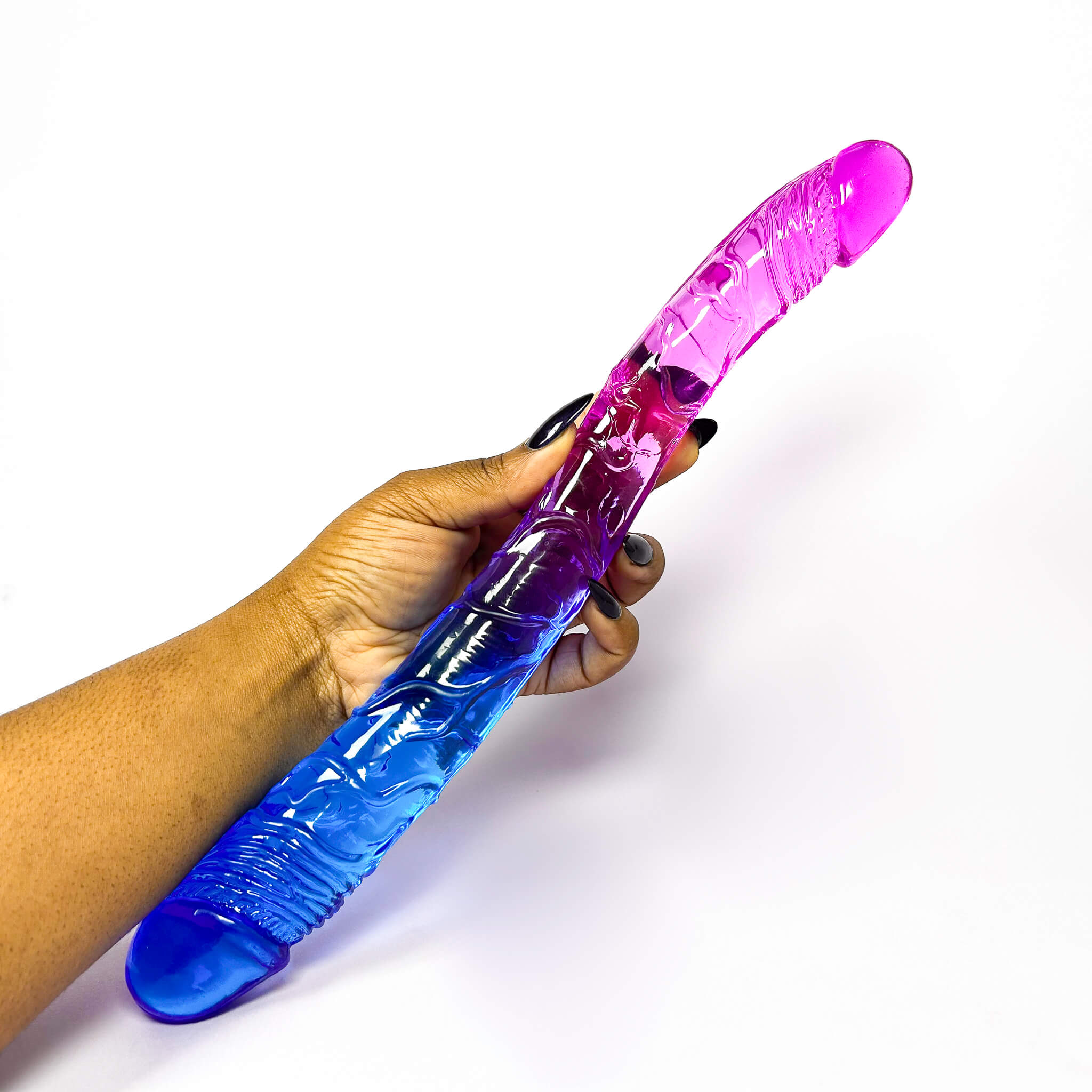 Hand holding a blue and purple buy double-sided dildo against a white background