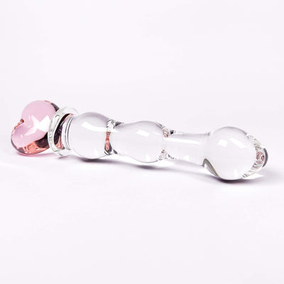 Glass dildo with pink and clear components on a white background