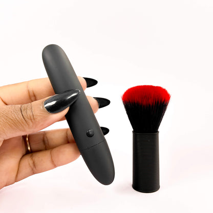 Black cosmetic brush vibrator with a red and black brush on a white background