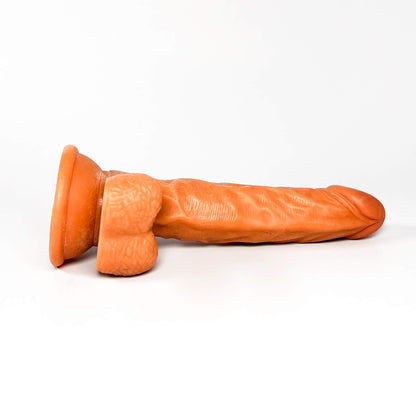 light brown dildo toy on a white background