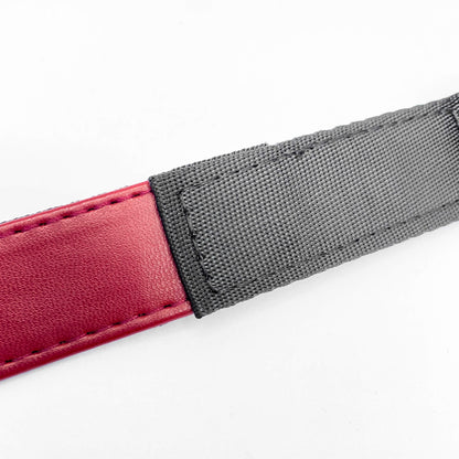 Close-up of a red and gray strap on a white background