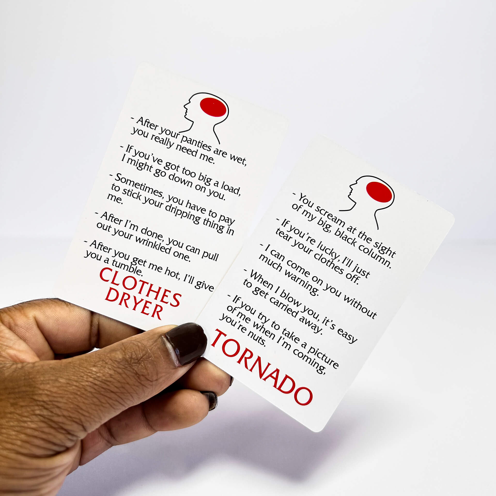 Hand holding dirty minds game questions with text and illustrations on a white background