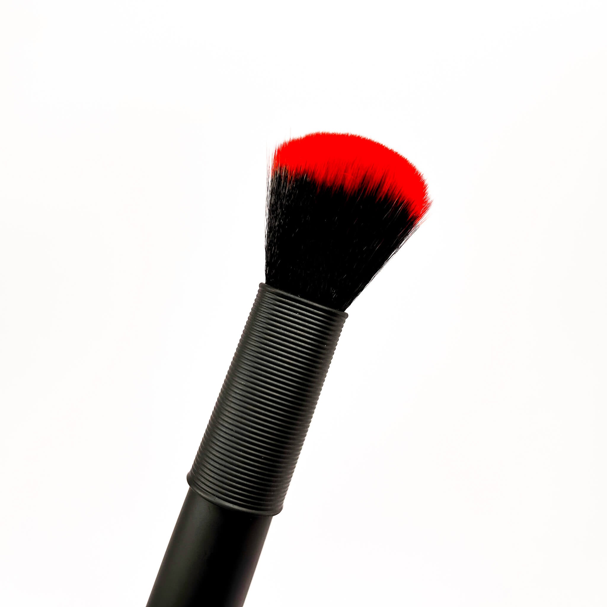 discreet brush vibrator with black handle and red bristle tip on a white background