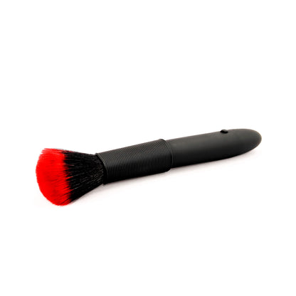 Black brush disguised vibrator with red bristles on a white background