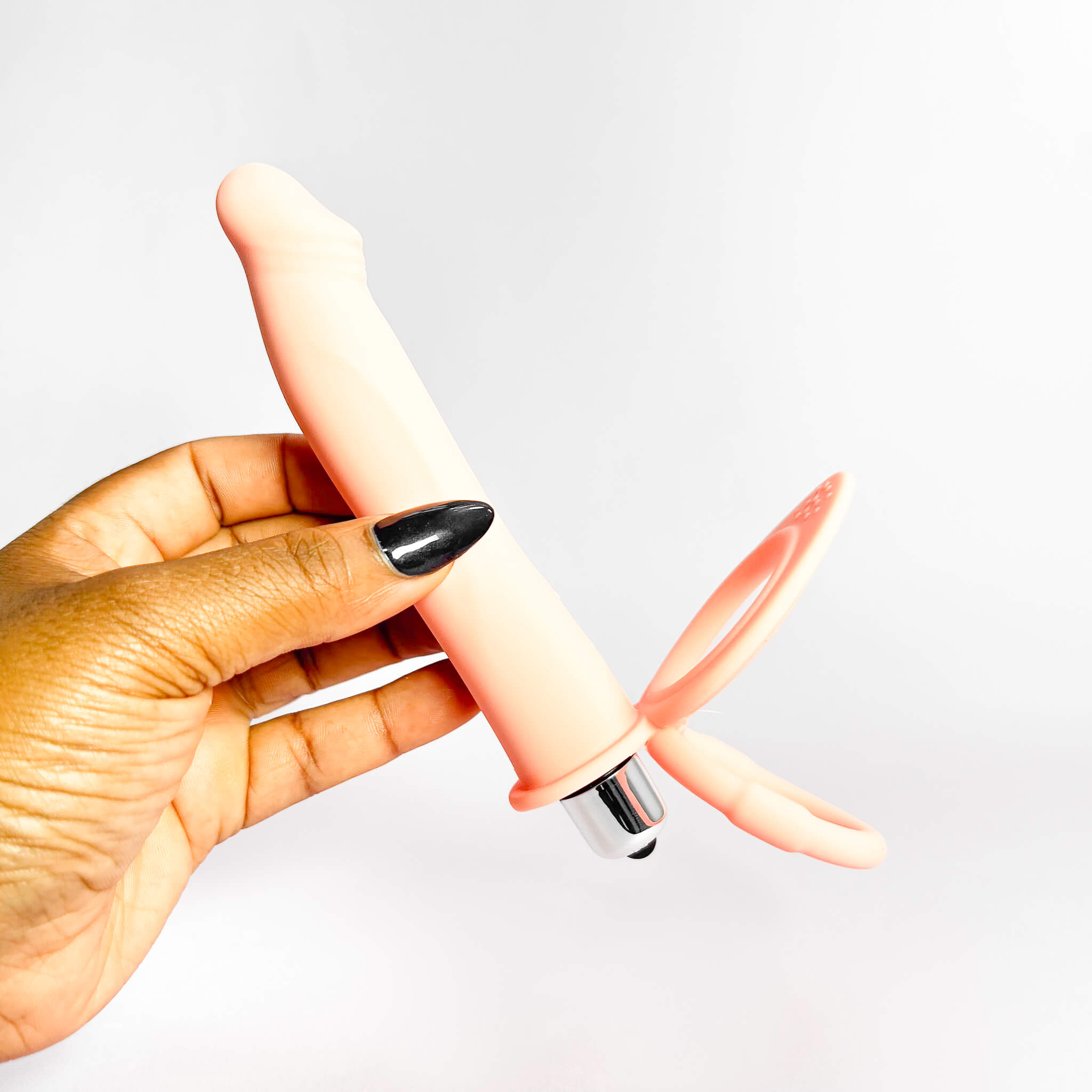 double penetrator penis ring with a white background