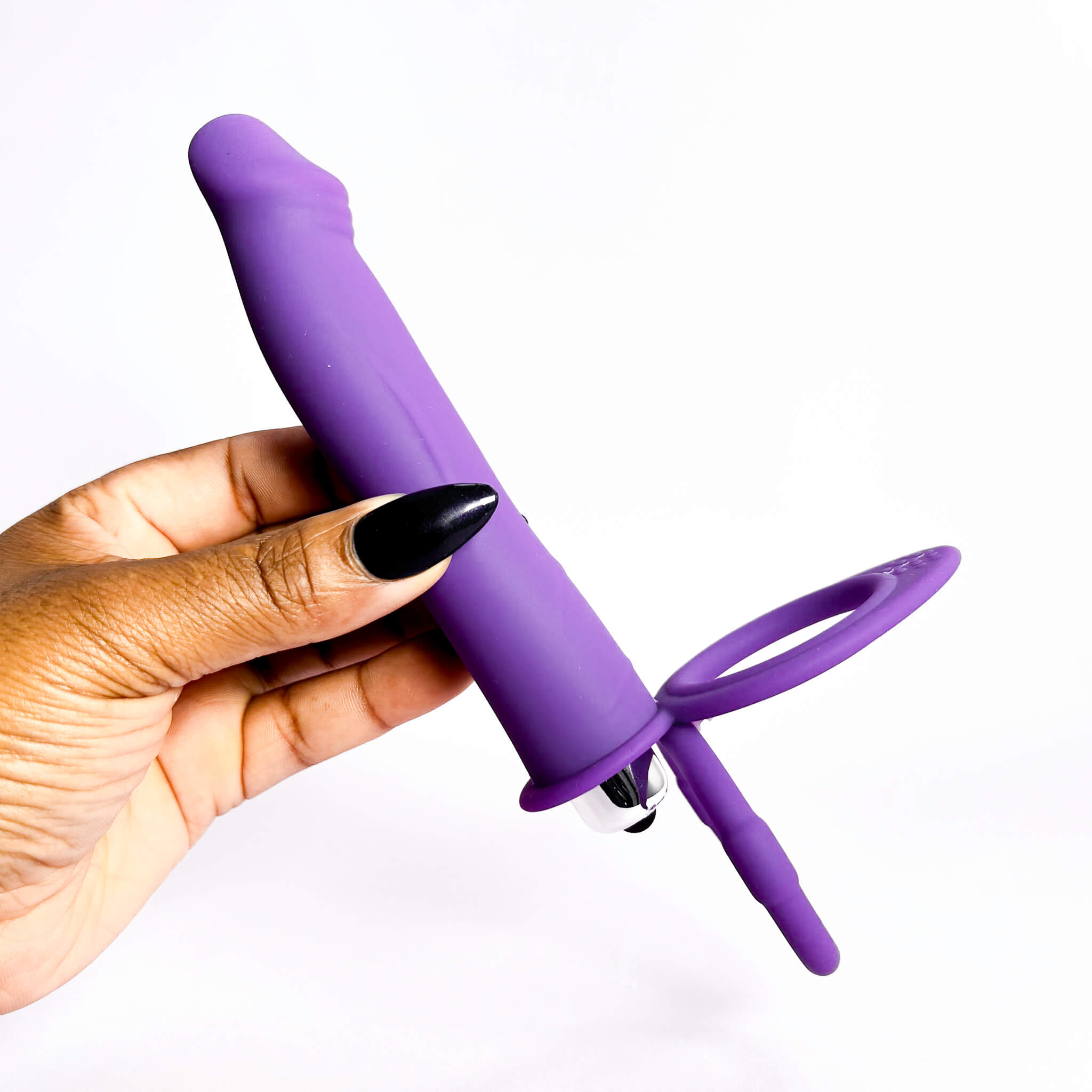 dp cock ring with handle held by a hand on a white background