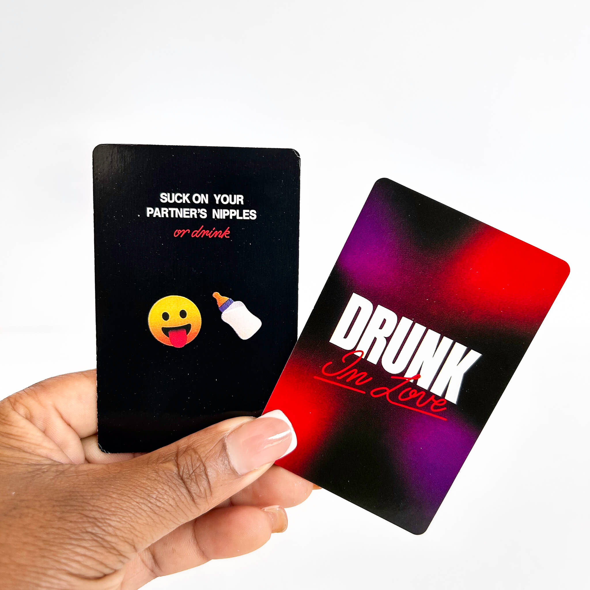 Two playing cards held by a hand, one with text and emoji, the other with 'DRUNK I'm Love' text.