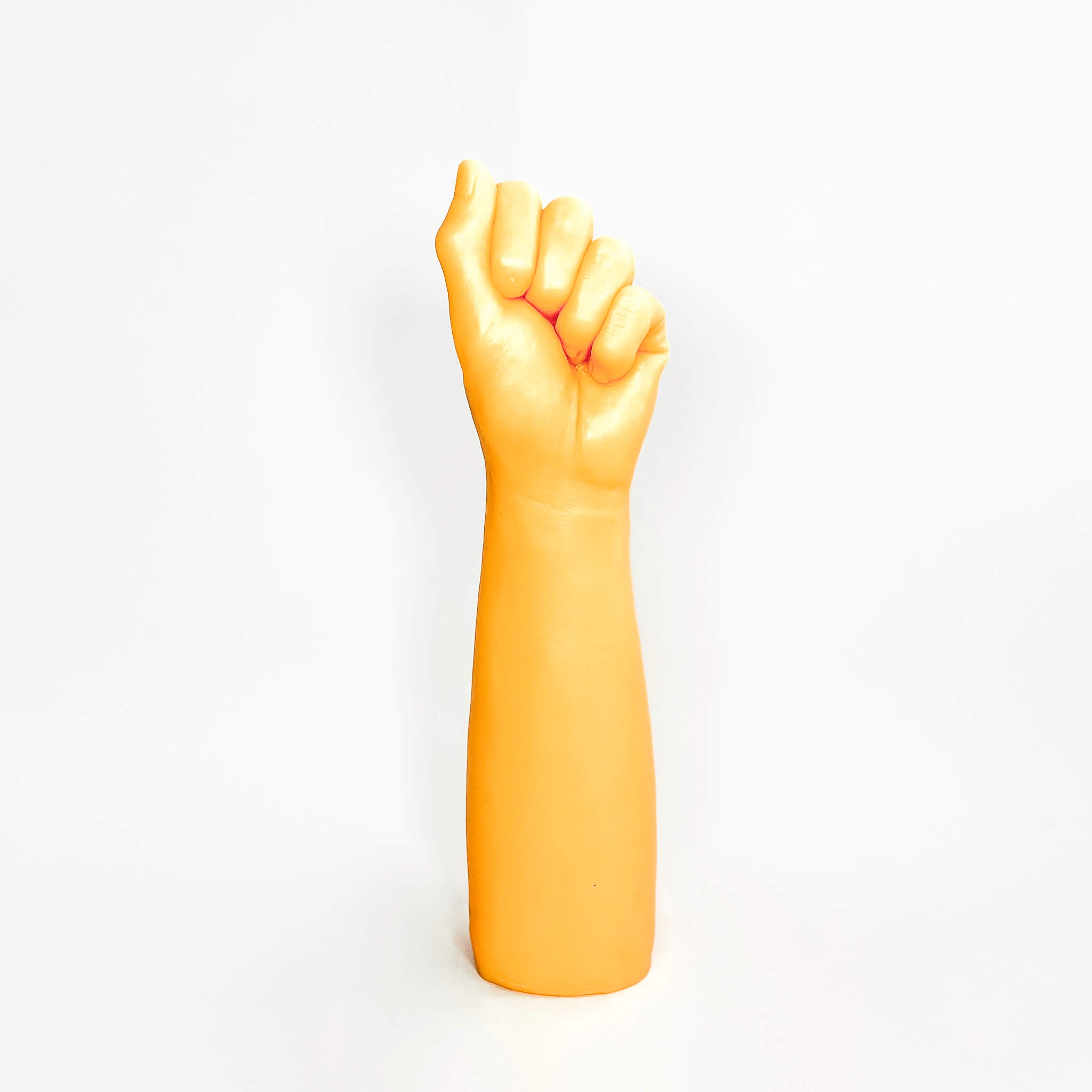 Dildo with a clenched fist on a white background