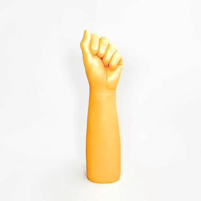 Dildo with a clenched fist on a white background