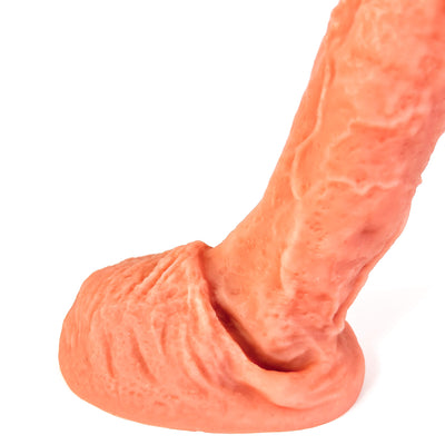 A realistic peach-colored silicone dildo with textured details, shown on a plain white background.
