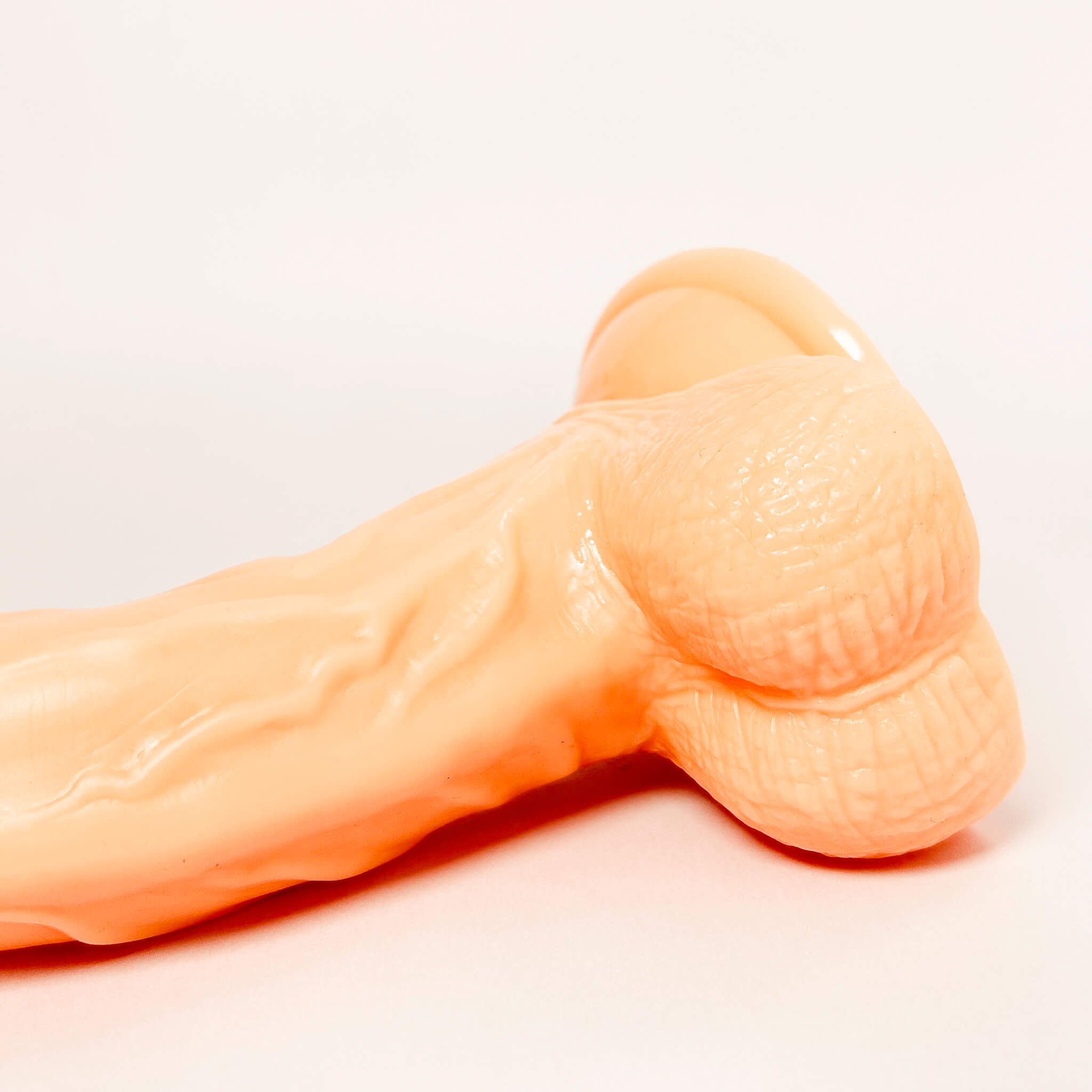 g-spot curved dildo on a light gray background