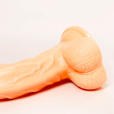 g-spot curved dildo on a light gray background