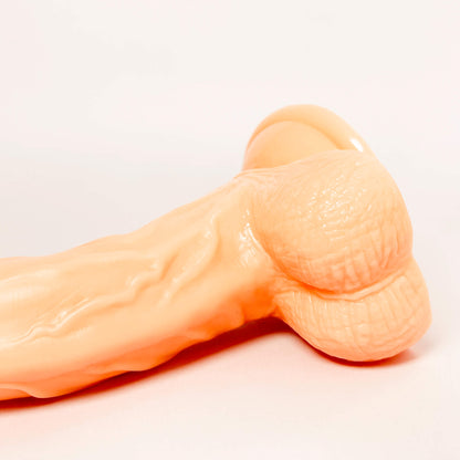 g-spot curved dildo on a light gray background