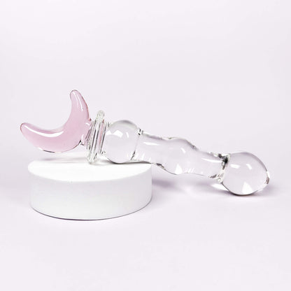 glass anal toys with pink accent on a white background