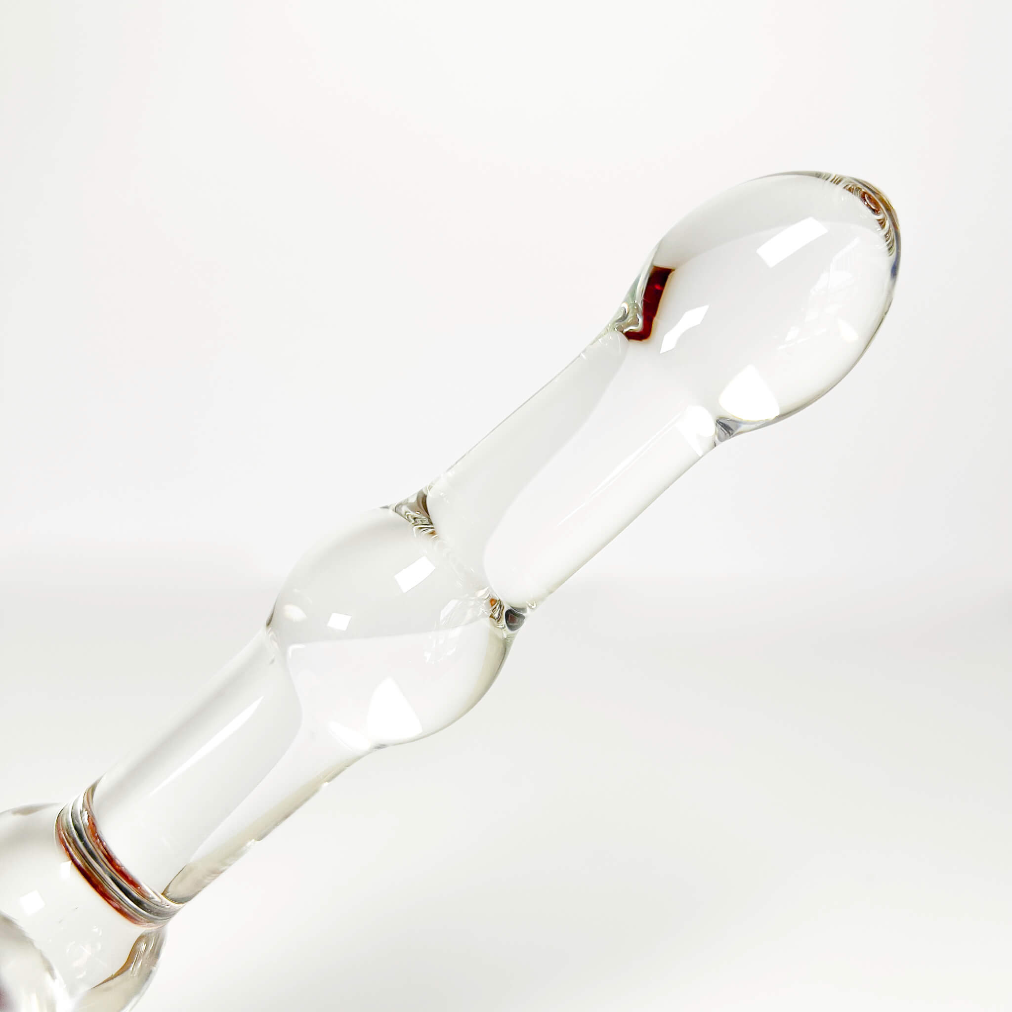 Clear glass dildo on a white background