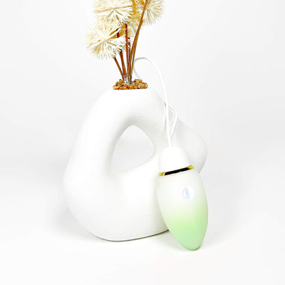 jumping egg sex toy with a green accent on a white background