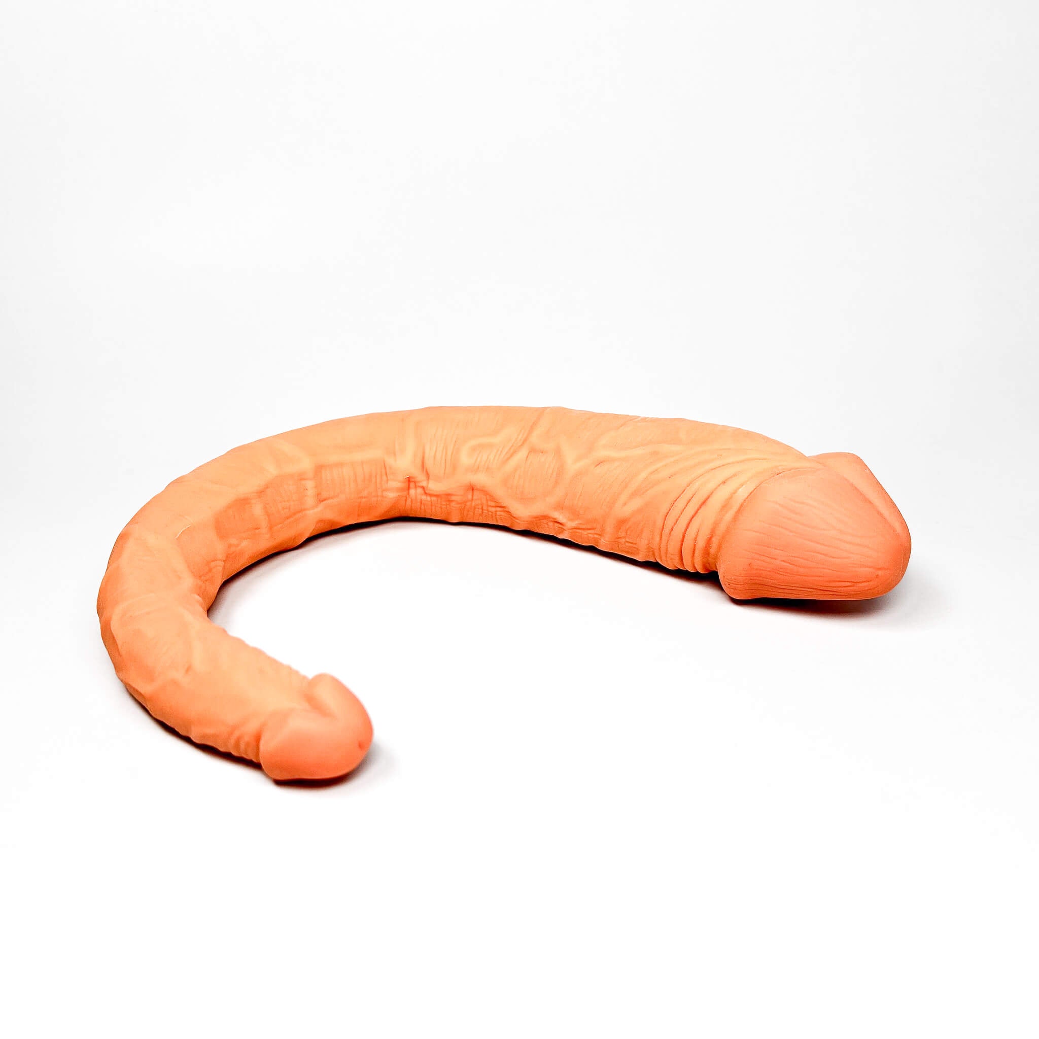 realistic double-ended dildo on a white background