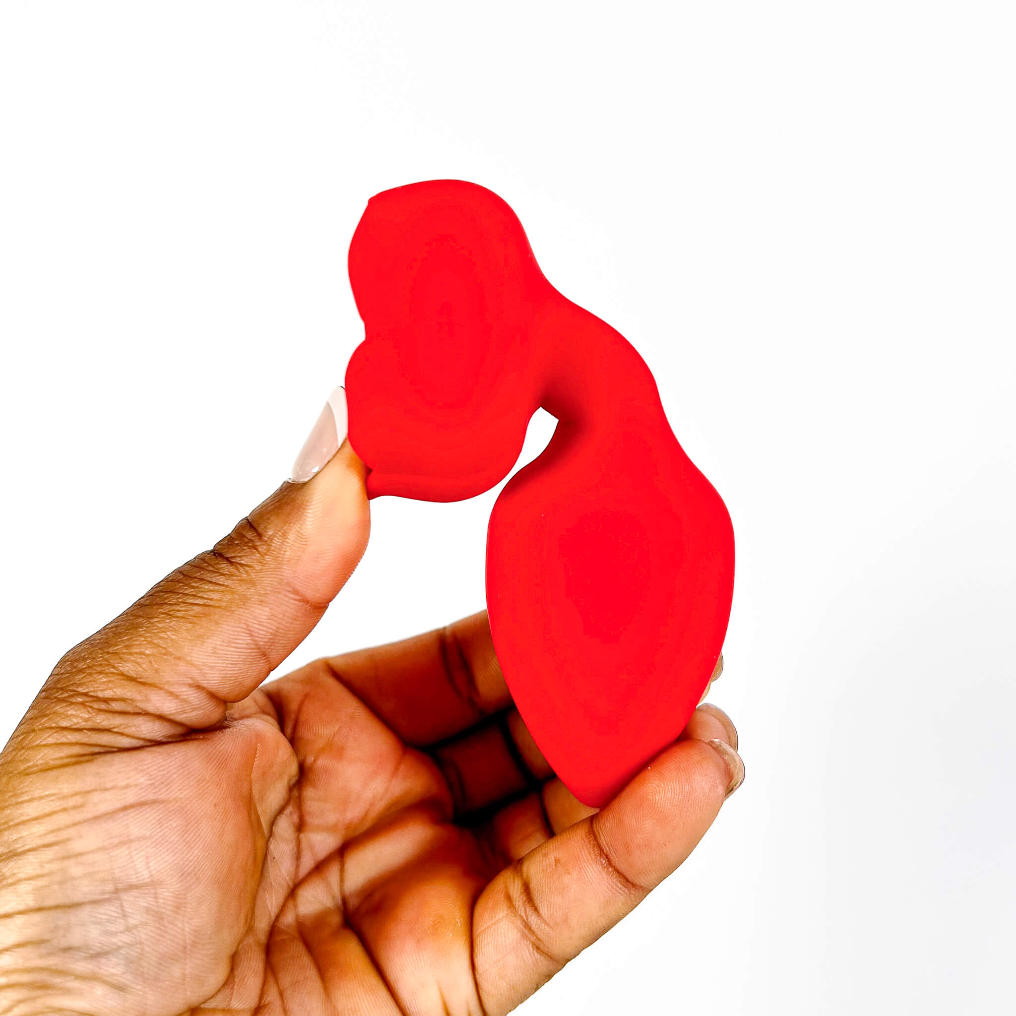 rose remote butt plug held in a hand against a white background