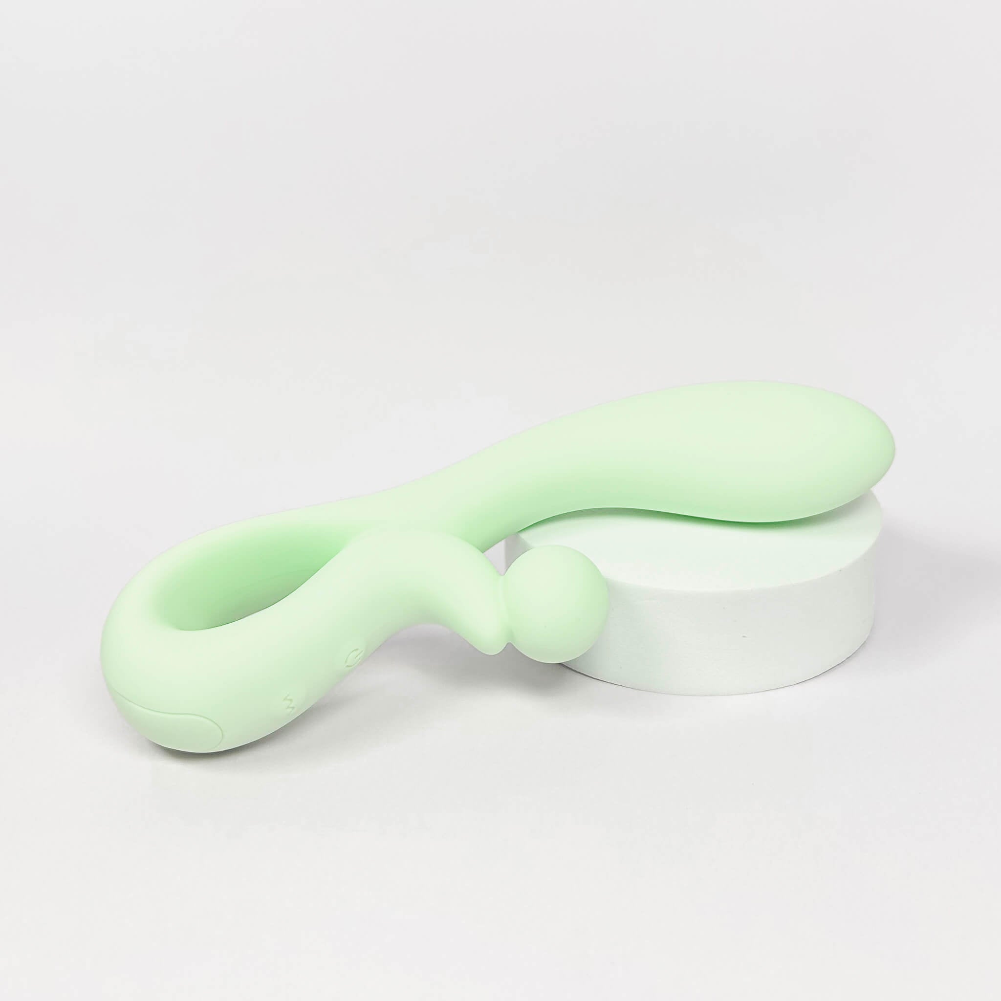 Light green silicone rabbit vibrator on a white background