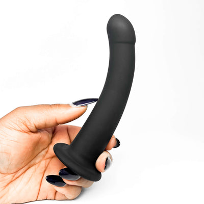 Black curved small strap on held in a hand with a white background