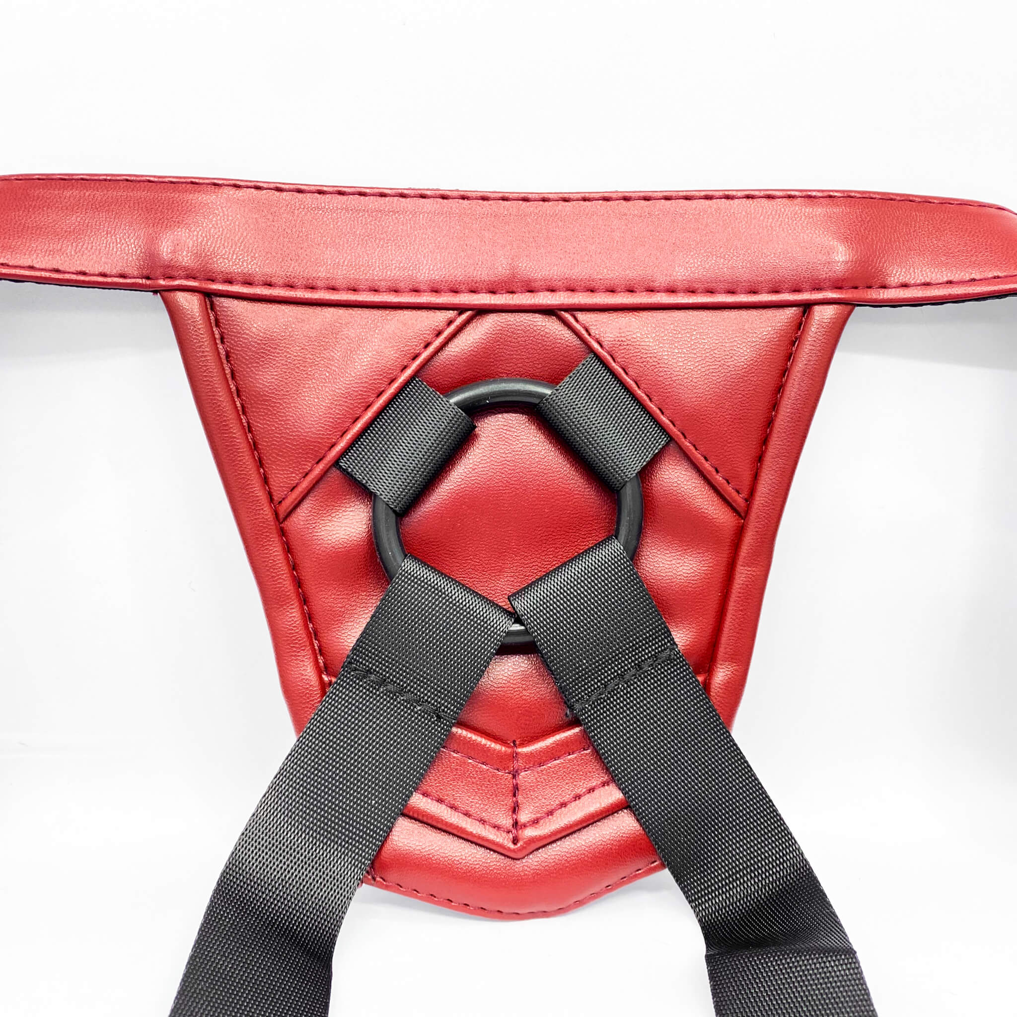 Red leather strap on harness with black straps on a white background