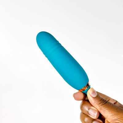 Hand holding a blue telescopic licking vibrator against a white background