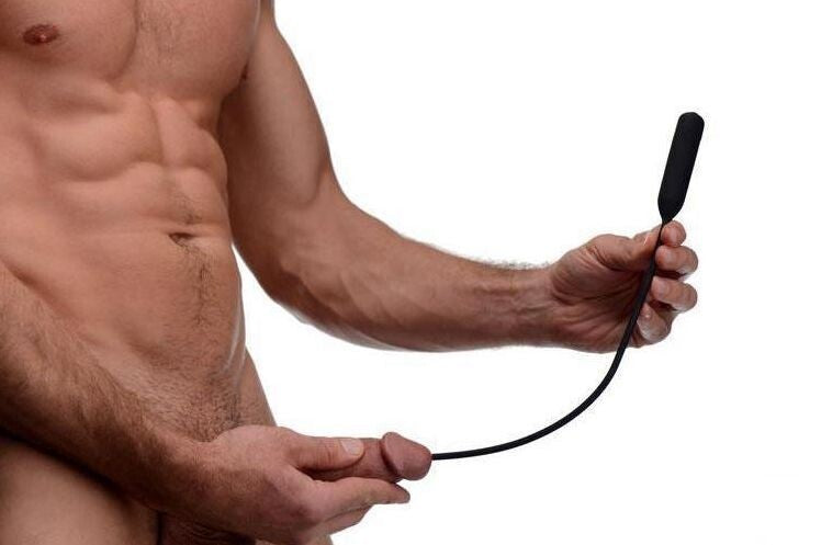 Man holding a urethral plug on a white background